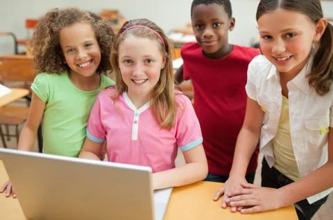 Smiling students using laptop Stock Photos