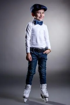Smiling stylishly dressed boy posing in ice skates Stock Photos