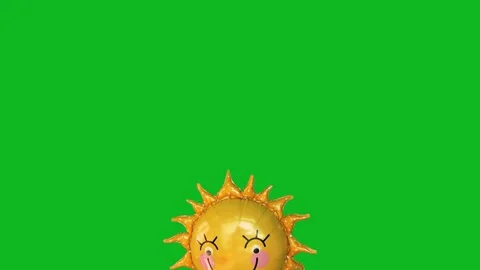 Smiling sun foil balloon floating upwards isolated on green background. Stock Footage 343094959