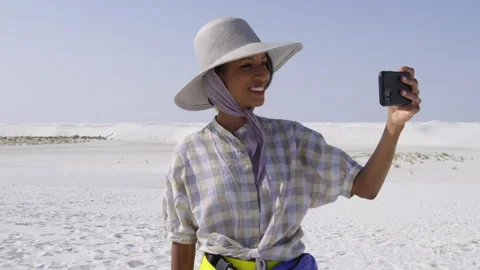 Smiling in the sun at a white sand beach on a clear blue sky day Stock Footage 312643582