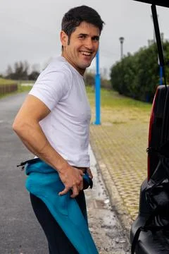 Smiling surfer preparing for the sea. Stock Photos