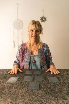 Smiling tarot reader looking at the camera and about to read the cards Stock Photos