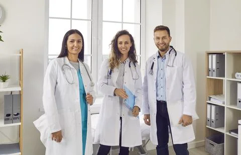 Smiling Team of Doctors and Nurses at Work in the Hospital Stock Photos