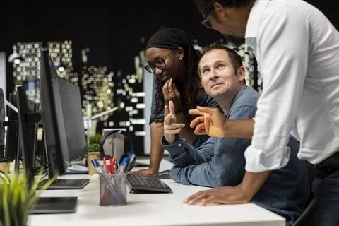 Smiling team of engineers in startup office, coding machine learning models 스톡 사진
