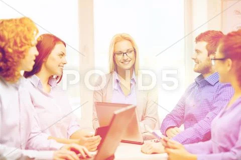 Smiling team with laptop and table pc computers Stock Photos
