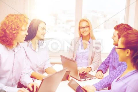 Smiling team with laptop and table pc computers Stock Photos