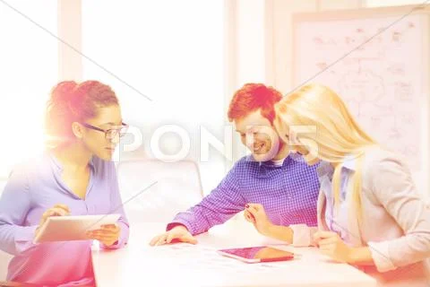 Smiling Team With Table Pc And Papers Working