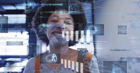 Smiling tech worker wearing gray top with rust straps, viewing holographic 写真素材
