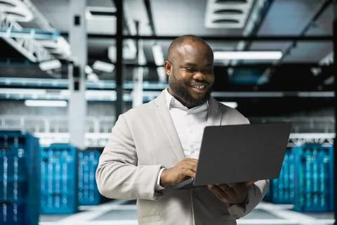 Smiling technician in data center workspace running system diagnostic tests Stock Photos