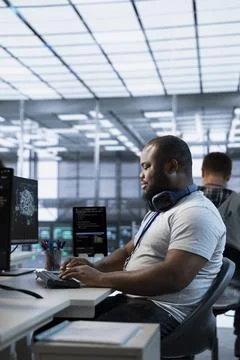 Smiling technician working in high tech data center workplace Stock Photos