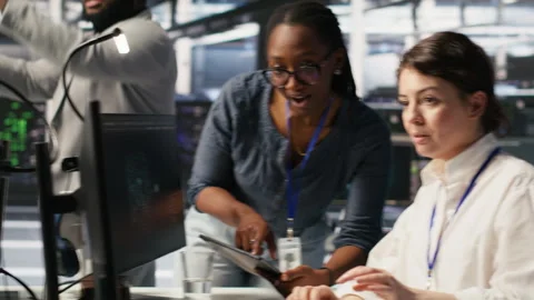 Smiling technicians doing fist bump in AI data center Stock Footage 309365335