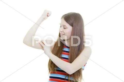 Smiling teenage girl measures her biceps Stock Photos