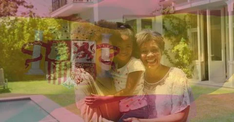 Smiling three generations posing in backyard near pool wearing casual summer Stock Photos