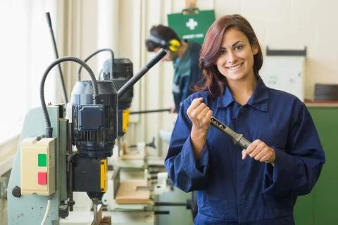 Smiling trainee showing tool 写真素材