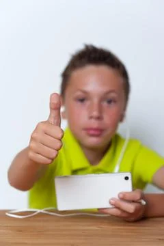 Smiling tween boy using his smartphone Stock Photos