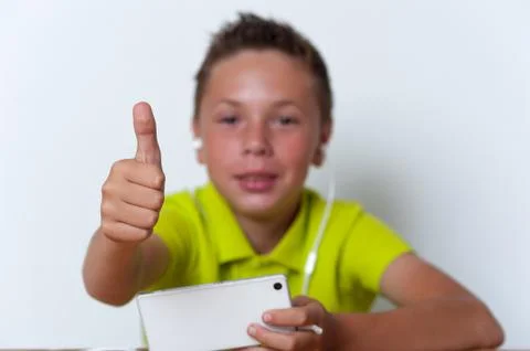 Smiling tween boy using his smartphone Stock Photos