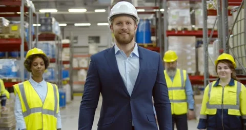 Smiling warehouse team with boss in large warehouse Stock Footage 151399101