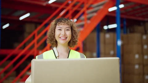 Smiling Warehouse Worker Holding a Box. Stock Footage 277538941