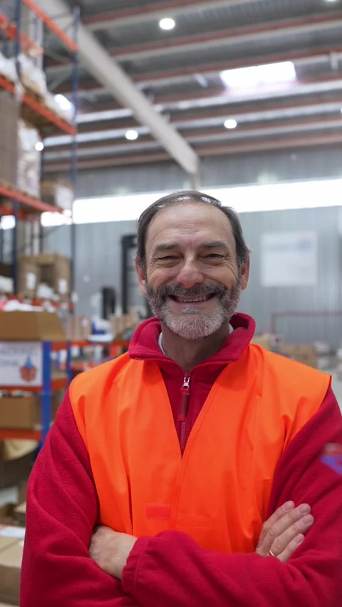 Smiling warehouse worker posing with crossed arms Stock Footage 312856460