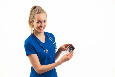 A smiling white-skinned nurse presenting a photo of an embryo - closeup Stock Photos