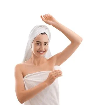 Smiling woman applying solid deodorant on white background 스톡 사진