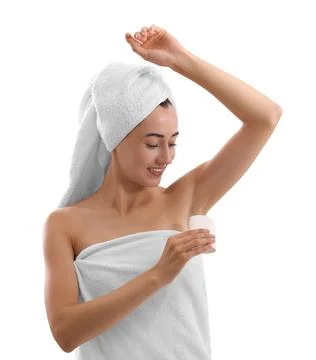 Smiling woman applying solid deodorant on white background Stock Photos
