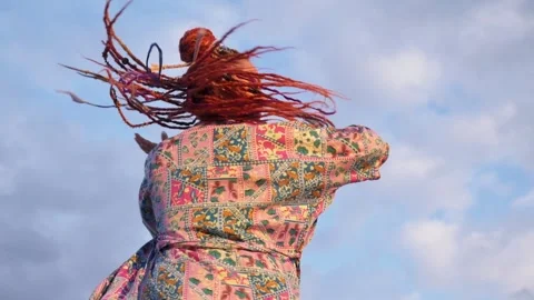 Smiling woman with boho dreadlocks dances on sky background. Slow motion Stock Footage 288833281