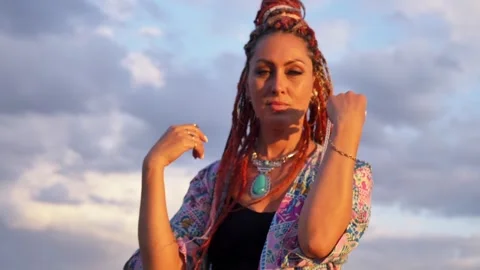 Smiling Woman with boho dreadlocks dancing on sky background. Slow motion. Close Stock Footage 288833484