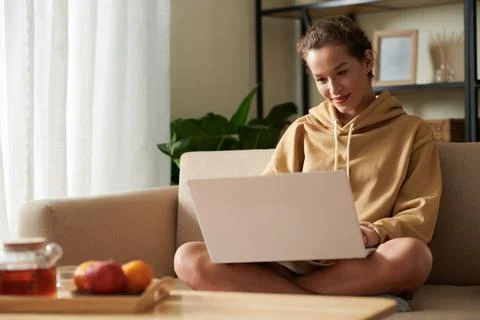 Smiling Woman Coding on Laptop 스톡 사진