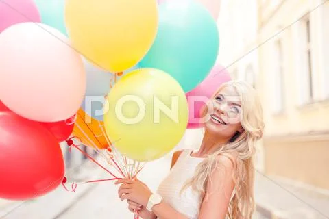 Smiling woman with colorful balloons Stock Photos