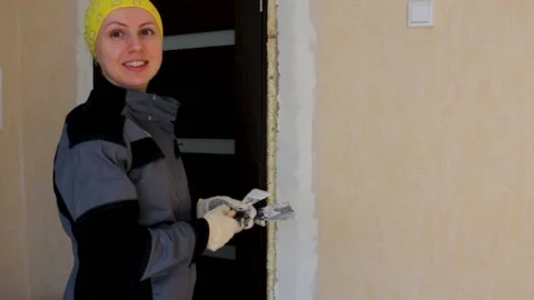 Smiling woman doing repairs Stock Footage 90494445