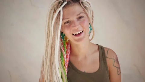 Smiling woman with dreadlocks looking at camera Stock Footage 139299223