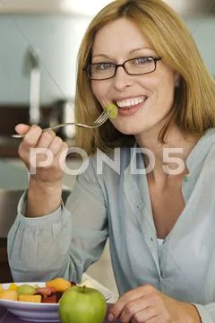 Smiling Woman Eating Fruit Salad
