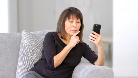 Smiling woman enjoying smartphone video Stock Video Pond5