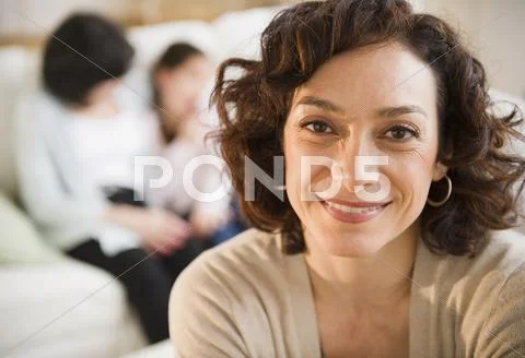 Smiling woman with family in background Stock Photos