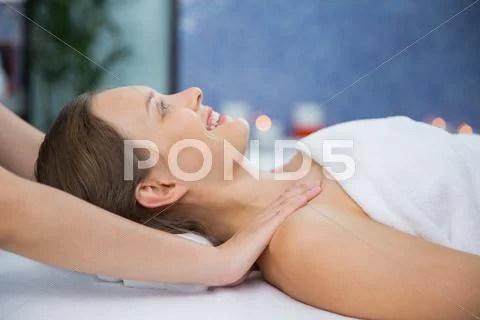 Smiling woman having neck and collar area massage Stock Photos