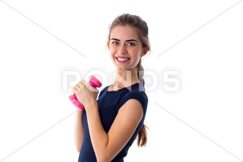 Smiling woman holding two dumbbells Stock Photos