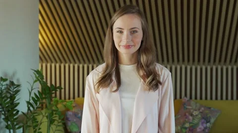 Smiling woman looking at camera posing alone at home, happy woman looks at the Stock-Footage 151336545