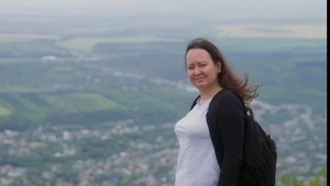 Smiling woman looking Camera stands on top of hills Mountain Landscape valley Stock Footage 291499862