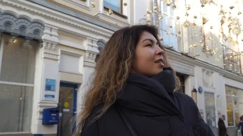 Smiling woman looking out while standing in a quiet metropolitan city in Moscow Stock Footage 101872548