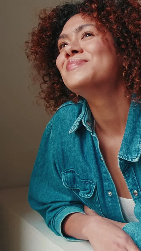 Smiling woman looking through window while relaxing on sofa Stock Footage 272792138