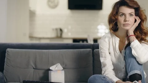 Smiling woman looking tv program at kitchen. Relaxed woman checking tv channels Video stock 113274694