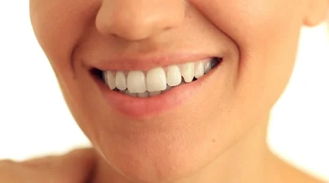 Smiling woman mouth with great white teeth close up, isolated on white HD Stock Footage