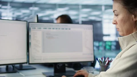 Smiling woman at PC checking servers bottlenecks leading to malfunctions Stock Footage 319240722
