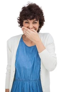 Smiling woman placing her hand on her mouth Stock Photos