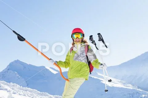 Smiling woman in ski suit lifting on button lift Stock Image #74784121