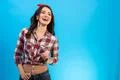 The smiling woman standing on the blue background Photo
