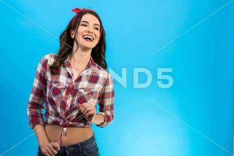 The smiling woman standing on the blue background Stock Photos