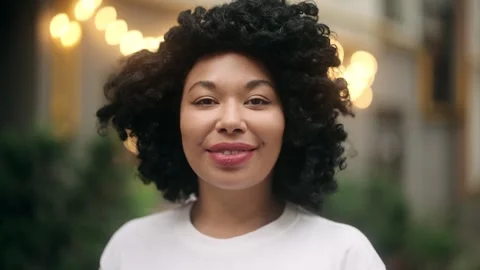 Smiling woman turns head toward camera and looks directly, showing positive Stock Footage 315972772