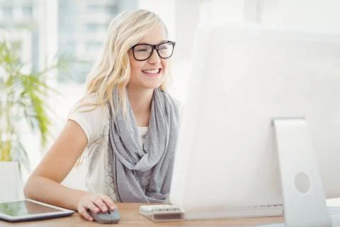 Smiling woman using computer Stock Photos